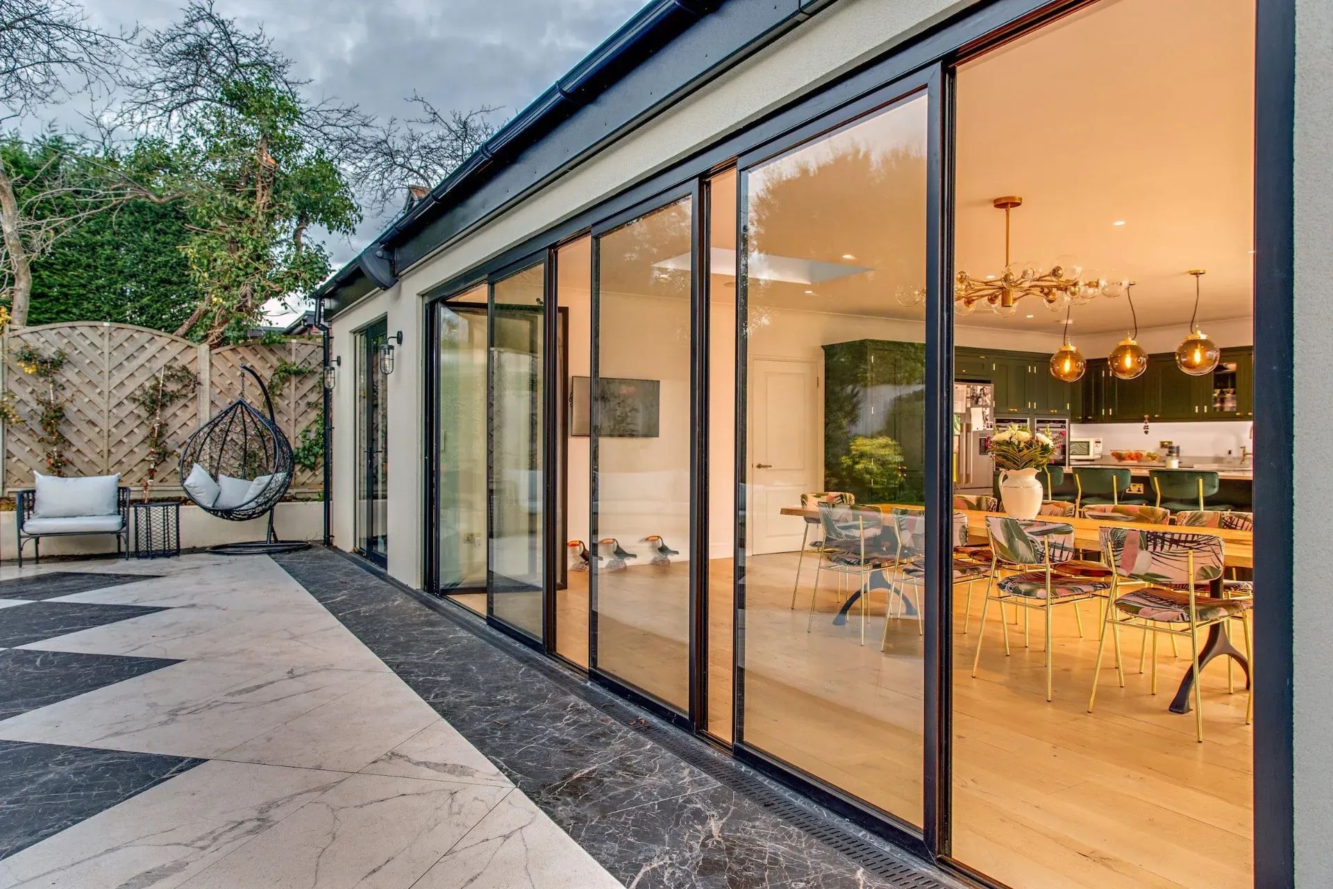 Aluminum sliding glass patio door open to a modern Houston home